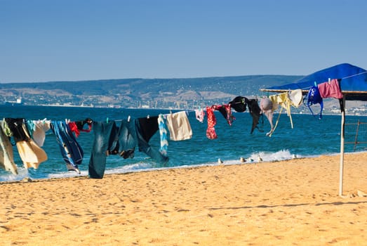 Washed clothes drying on the beach