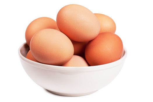 Brown eggs in a bowl over white background