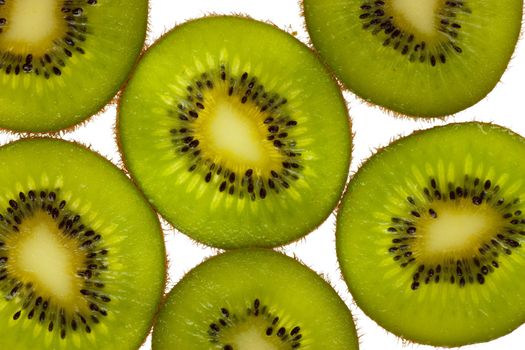 Close-up view of kiwi slices over white background