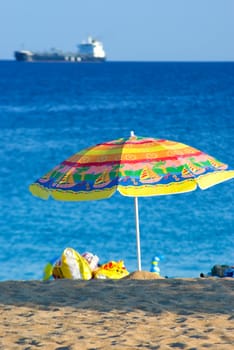 Beach umbrella on a sunny day, sea in background 






 





