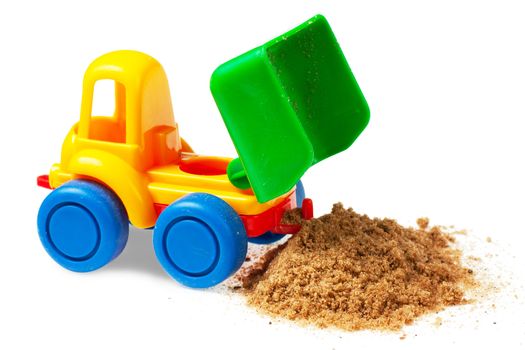 Colorful toy truck with sand over white background