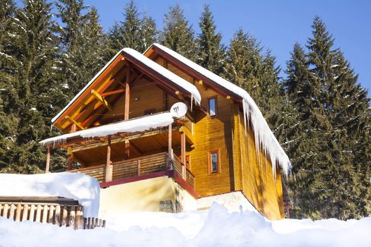 Wooden chalet in winter mountain in Carpathians