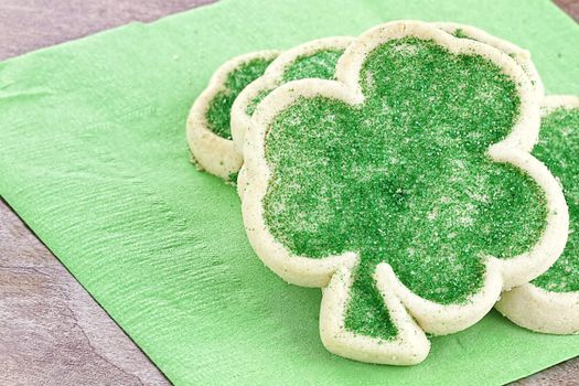 Freshly baked St. Patrick's Day sugar cookies on a green napkin. 
