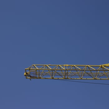 yellow construction crane and blue sky