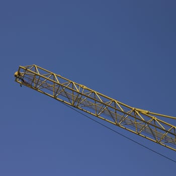 yellow construction crane and blue sky