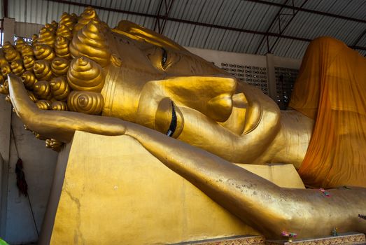 Big golden head of Reclining Buddha Image (Phra Norn) at Paa Jareon Tham temple, Chiangmai, Thailand