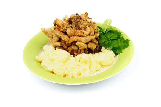 Beef Stroganoff with Mashed Potato and Greens on Yellow Plate closeup. Traditional Russian Dish