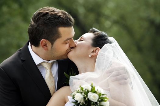 Newly-married couple in park