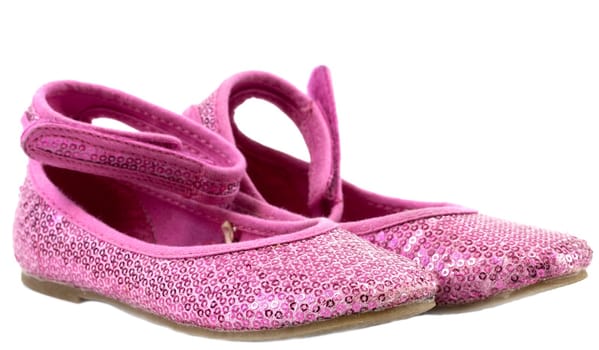 Glittering pink children's shoes isolated on white