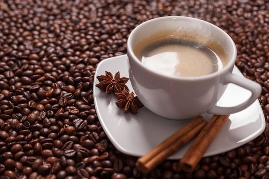 Coffee cup with spices and coffee beans background 