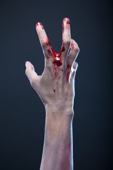 Bloody zombie hand, studio shot 