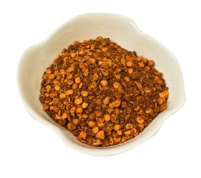 Paprika ground in a white bowl on white background.