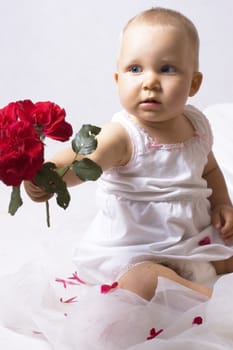 little girl is hand over a red flower, great for mother's day,







little  girl