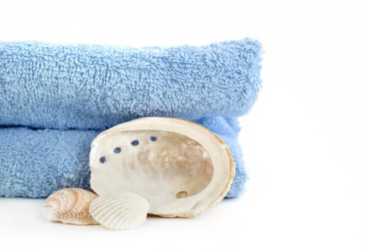 blue towel and sea shell isolated on white