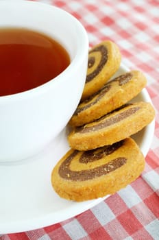 herbal tea and cookies on red cloth