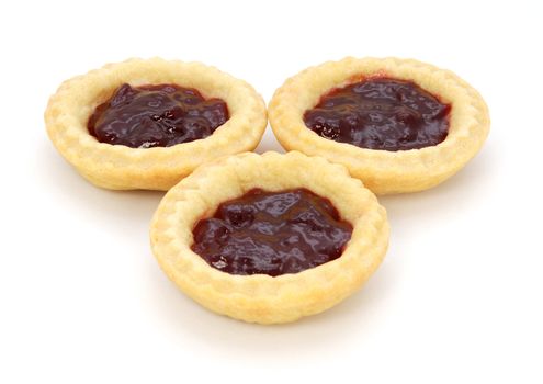 Three delicious jam tarts, isolated on a white background