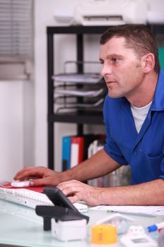 Plumber using a desktop computer