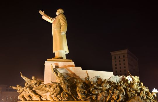 Mao Statue Long Side View With Heroes, Zhongshan Square, Shenyang, Liaoning Province, China at Night Lights Famous Statue built in 1969 in middle of Cultural Revolution.