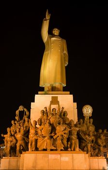 Mao Statue Heroes, Zhongshan Square, Shenyang, Liaoning Province, China at Night Lights Famous Statue built in 1969 in middle of Cultural Revolution.  Hero holding up a book of Mao Zedong thought.