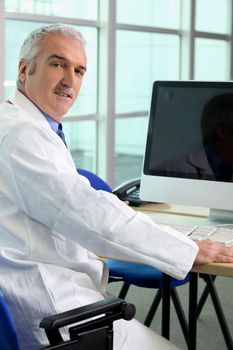 Doctor sat at computer