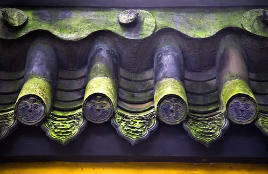 Roof Tiles Faces Green Moss Baoguang Si Shining Treasure Buddhist Temple Chengdu Sichuan China Front of Temple