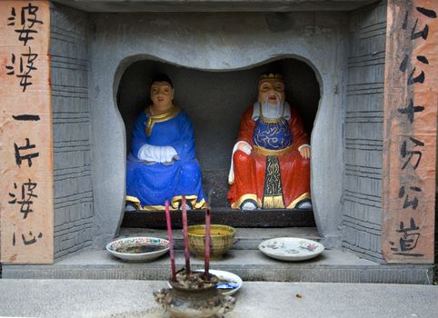 Chinese Stree Shrine to Happy Household, Jinli Street, Chengdu, Sichuan, China

The Chinese saying is mother in law is very kind and father in law is very fair.

Resubmit--In response to comments from reviewer have further processed image to reduce noise, sharpen focus, and adjust lighting.


