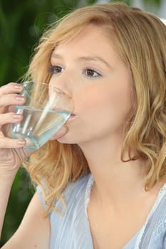 Blond woman drinking water