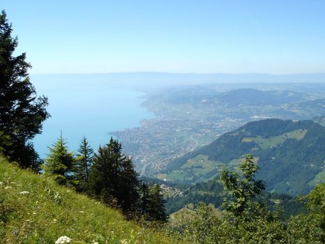 View on Montreux city and Geneva lake from the Alps mountains by beautiful summer day, Switzerland
