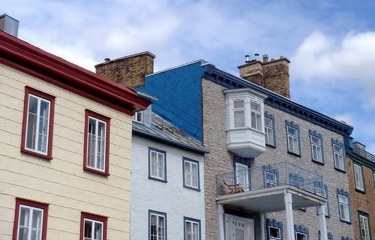 Facades of colored old houses in old Quebec by cloudy weather, Canada