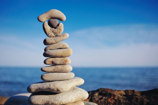 Pile of pebbles each other on a sea boulder