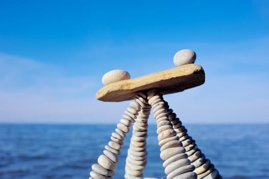 Balancing of white stones on the top of pyramidal stack
