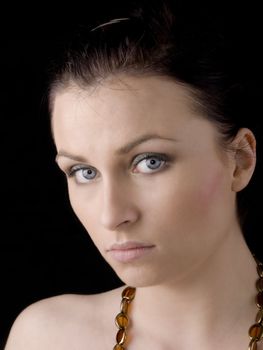 Portrait of young natural looking woman on black background