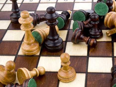 Closeup picture of wooden chess-men on chessboard.