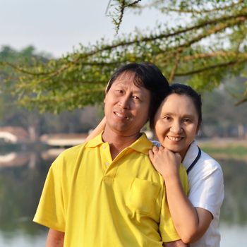 Happy mother and father in the park outdoor