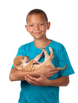 A young boy enjoys holding his puppy dog in his arms.