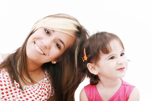 Teen sister and baby sister. Cute sisters portrait, close up, isolated on white