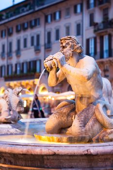 Northward view of the Piazza Navona with the fontana del Moro (the Moor Fountain) and the Sant'Agnese in Agone church at dusk - Rome, Italy