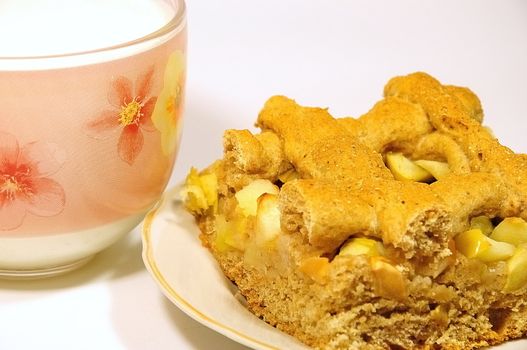 piece of apple pie and a cup of milk closeup