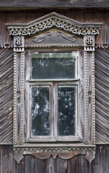 Carved window in old russian wooden country house