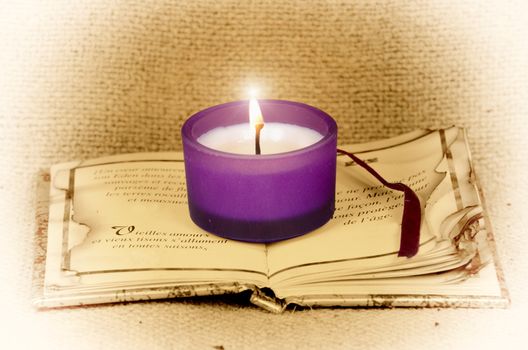 create poetic atmosphere with this candle on a book