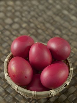 close up of a basket of chinese baby first birthday red eggs