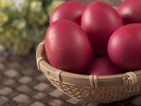 close up of a basket of chinese baby first birthday red eggs