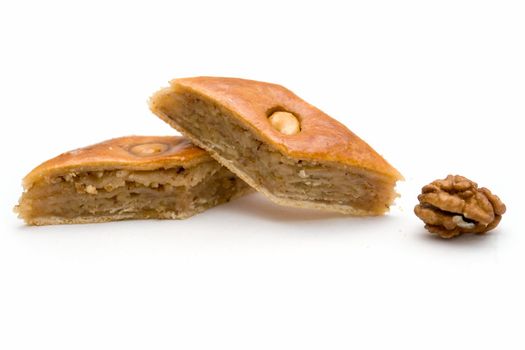 Baklava and walnut. East sweets on a white background