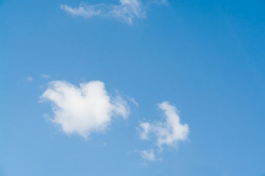 Small white cloud in the blue sky.