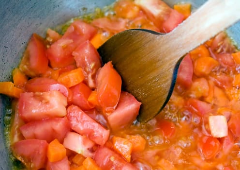 Cooking. Stewed red tomatoes close up.