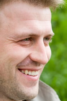 smiling young man on a green background