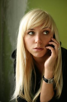 The nice blonde with the phone on a green background