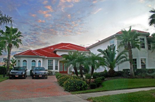 New Home at Sunset with matching cars in front