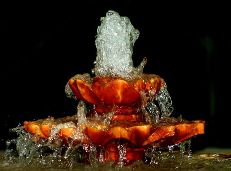 A fountain with water spraying from the top.