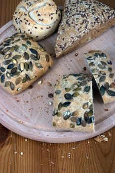 A group of multi-grain bread, on a chopping board